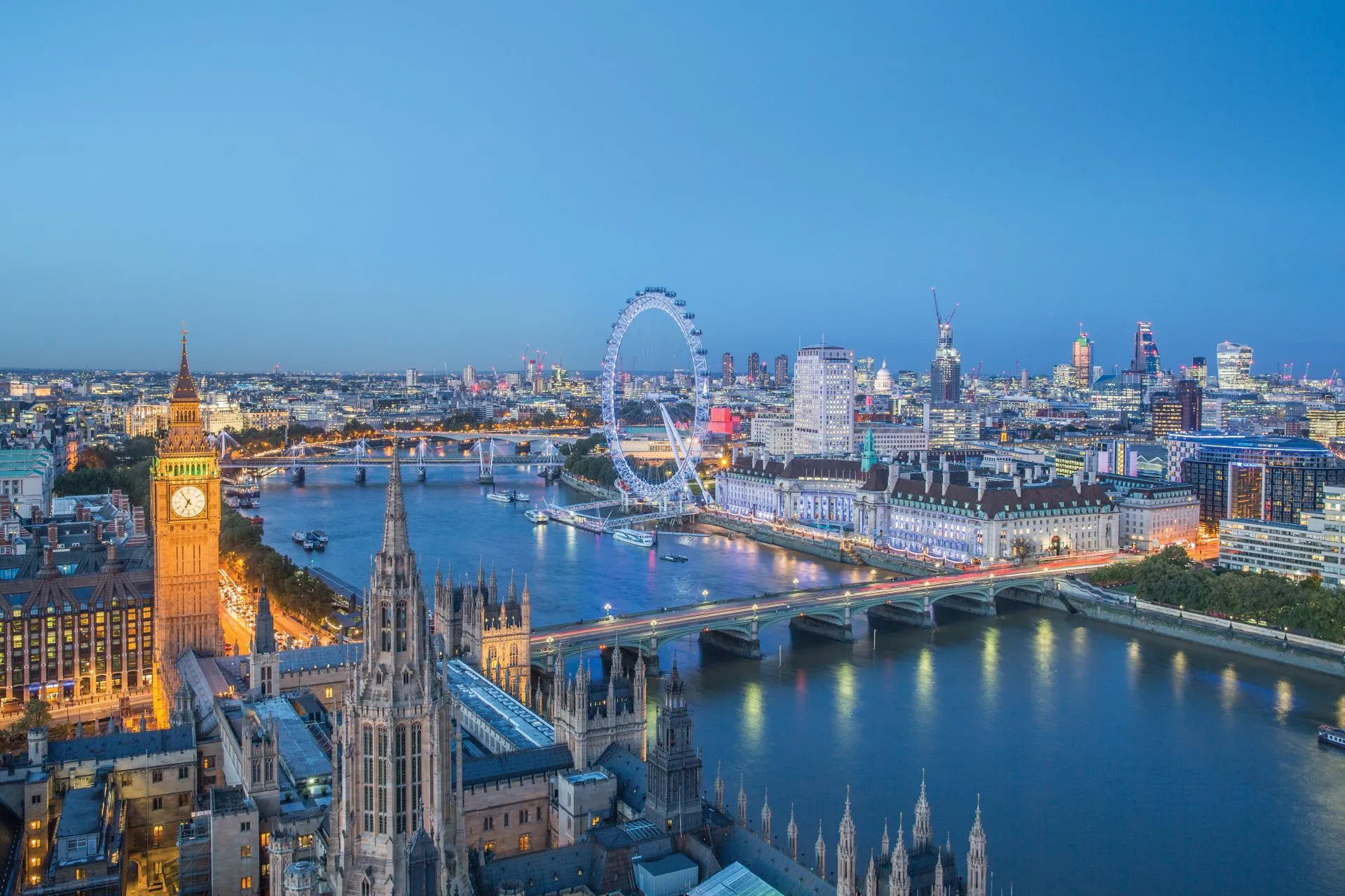 London skyline with Big Ben and the London Eye at dusk